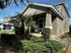 Inviting two-story home featuring manicured front yard landscaping and a charming covered front porch at 11456 Short Story St, Orlando, FL 32832