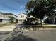 Inviting two-story home with a paved driveway, neat landscaping, and a cozy front porch in a residential neighborhood at 11456 Short Story St, Orlando, FL 32832