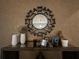 Elegant hallway decor with a decorative mirror, glass table, and decorative vases and picture frames at 11456 Short Story St, Orlando, FL 32832