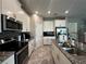 Bright kitchen featuring white cabinets, stainless steel appliances, granite counters, and tile flooring at 11456 Short Story St, Orlando, FL 32832