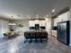 Open kitchen boasts granite countertops, stainless steel appliances, and a kitchen island with seating for casual dining at 11456 Short Story St, Orlando, FL 32832