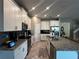 Modern kitchen with white cabinetry, granite countertops, stainless steel appliances, and tile flooring at 11456 Short Story St, Orlando, FL 32832