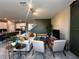 Open-concept living area flows into kitchen, featuring stylish furnishings and a barn door detail at 11456 Short Story St, Orlando, FL 32832