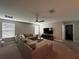 Large living room featuring a sectional couch, ceiling fan, and entertainment center at 11456 Short Story St, Orlando, FL 32832
