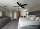 Spacious bedroom featuring a king bed, ceiling fan, and a dresser at 11456 Short Story St, Orlando, FL 32832