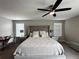 Spacious main bedroom with large bed, ceiling fan, and a work desk near the windows at 11456 Short Story St, Orlando, FL 32832