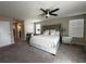 Spacious bedroom featuring a king bed, ceiling fan, and an office desk at 11456 Short Story St, Orlando, FL 32832