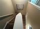 View from the top of the carpeted stairway with white handrails and landing at 11456 Short Story St, Orlando, FL 32832