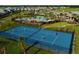 Aerial view of community tennis courts with neighborhood homes and manicured landscaping at 11456 Short Story St, Orlando, FL 32832