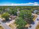 Aerial of the home from the corner, featuring the lush neighborhood at 1298 Scottsdale Dr, Ormond Beach, FL 32174