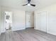 Bedroom showcasing new flooring, a ceiling fan, and convenient access to an attached bathroom at 1298 Scottsdale Dr, Ormond Beach, FL 32174