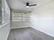This bedroom features wood-look floors, fresh paint, and an updated ceiling fan at 1298 Scottsdale Dr, Ormond Beach, FL 32174