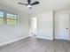 Airy bedroom with fresh paint, new floors and a ceiling fan presents a serene and inviting atmosphere at 1298 Scottsdale Dr, Ormond Beach, FL 32174