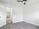 Empty bedroom showcasing a new ceiling fan, fresh paint, and stylish, easy-to-clean gray flooring at 1298 Scottsdale Dr, Ormond Beach, FL 32174