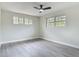 Comfortable bedroom boasting natural light, modern ceiling fan and new flooring, ready for relaxation at 1298 Scottsdale Dr, Ormond Beach, FL 32174