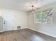 Dining room with modern light fixture, gray wood flooring and windows with plenty of natural light at 1298 Scottsdale Dr, Ormond Beach, FL 32174