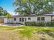 Charming single story home featuring lush landscaping and fresh exterior paint at 1298 Scottsdale Dr, Ormond Beach, FL 32174