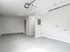 Spacious garage with modern lighting, painted walls, and painted floor at 1298 Scottsdale Dr, Ormond Beach, FL 32174