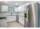 Bright kitchen features white cabinets, stainless steel appliances, and granite countertops at 1298 Scottsdale Dr, Ormond Beach, FL 32174