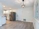 Dining area next to updated kitchen with stainless steel appliances and white cabinetry at 1298 Scottsdale Dr, Ormond Beach, FL 32174