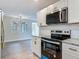 Updated kitchen features stainless appliances, granite countertops, and white cabinets at 1298 Scottsdale Dr, Ormond Beach, FL 32174