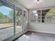 Sun room with sliding glass doors leading to a wooden deck at 1298 Scottsdale Dr, Ormond Beach, FL 32174