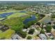 Aerial view of a home with solar panels near a lake and lush greenery, in a residential neighborhood at 1302 Shelter Rock Rd, Orlando, FL 32835