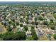 Aerial view of a neighborhood with homes, solar panels, and close proximity to a lake at 1302 Shelter Rock Rd, Orlando, FL 32835