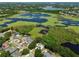 Aerial view of homes in a neighborhood near a lake, enhanced with solar panels for energy efficiency at 1302 Shelter Rock Rd, Orlando, FL 32835