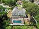 Aerial view of the home with a screened-in pool and spacious backyard with mature trees at 1302 Shelter Rock Rd, Orlando, FL 32835