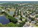 Aerial view of homes with solar panels near a lake and lush greenery in a residential neighborhood at 1302 Shelter Rock Rd, Orlando, FL 32835