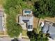 Aerial view of the backyard showing the solar panels, screened-in pool, and trees surrounding the property at 1302 Shelter Rock Rd, Orlando, FL 32835