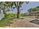 A scenic backyard has mature trees and views of the pool's screened enclosure at 1302 Shelter Rock Rd, Orlando, FL 32835