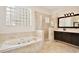 Luxurious bathroom features a soaking tub, walk-in shower, and tile flooring at 1302 Shelter Rock Rd, Orlando, FL 32835