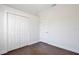 Bedroom featuring wood floors, white walls and closet with folding doors at 1302 Shelter Rock Rd, Orlando, FL 32835