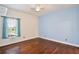 Bright bedroom with wood floors, painted accent wall, and a ceiling fan at 1302 Shelter Rock Rd, Orlando, FL 32835