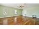 Large bedroom with hardwood floors, a ceiling fan, and bright natural light at 1302 Shelter Rock Rd, Orlando, FL 32835