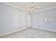 Simple bedroom featuring tile floors, white trim, neutral paint, and a ceiling fan at 1302 Shelter Rock Rd, Orlando, FL 32835