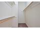Walk-in closet provides ample storage with wood shelving and neutral carpeting at 1302 Shelter Rock Rd, Orlando, FL 32835