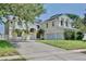 Two-story home featuring palm trees and a spacious driveway leading to a three-car garage at 1302 Shelter Rock Rd, Orlando, FL 32835