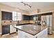 Well-lit kitchen with granite countertops, stainless steel appliances, and dark cabinets at 1302 Shelter Rock Rd, Orlando, FL 32835