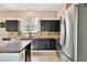 Kitchen featuring dark cabinets, stainless steel appliances, and tile backsplash at 1302 Shelter Rock Rd, Orlando, FL 32835