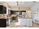 Spacious kitchen featuring dark cabinets, a stainless-steel refrigerator, and a kitchen island at 1302 Shelter Rock Rd, Orlando, FL 32835