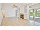 Bright living room with fireplace and sliding glass doors leading to the pool at 1302 Shelter Rock Rd, Orlando, FL 32835