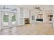 Spacious living room with built-in shelving, fireplace, and sliding glass doors at 1302 Shelter Rock Rd, Orlando, FL 32835