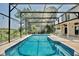 Screened pool area with attached patio and surrounding trees at 1302 Shelter Rock Rd, Orlando, FL 32835