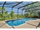 Enclosed pool area with stone patio and a backdrop of lush greenery at 1302 Shelter Rock Rd, Orlando, FL 32835