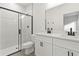 Modern bathroom with dual sinks, large mirror, and a glass-enclosed shower at 13247 Sw 83Rd Cir, Ocala, FL 34473