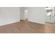Spacious bedroom with wood-style laminate flooring and bathroom with vanity at 13247 Sw 83Rd Cir, Ocala, FL 34473