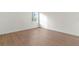 Well-lit bedroom features wood-style laminate flooring and a bright window at 13247 Sw 83Rd Cir, Ocala, FL 34473